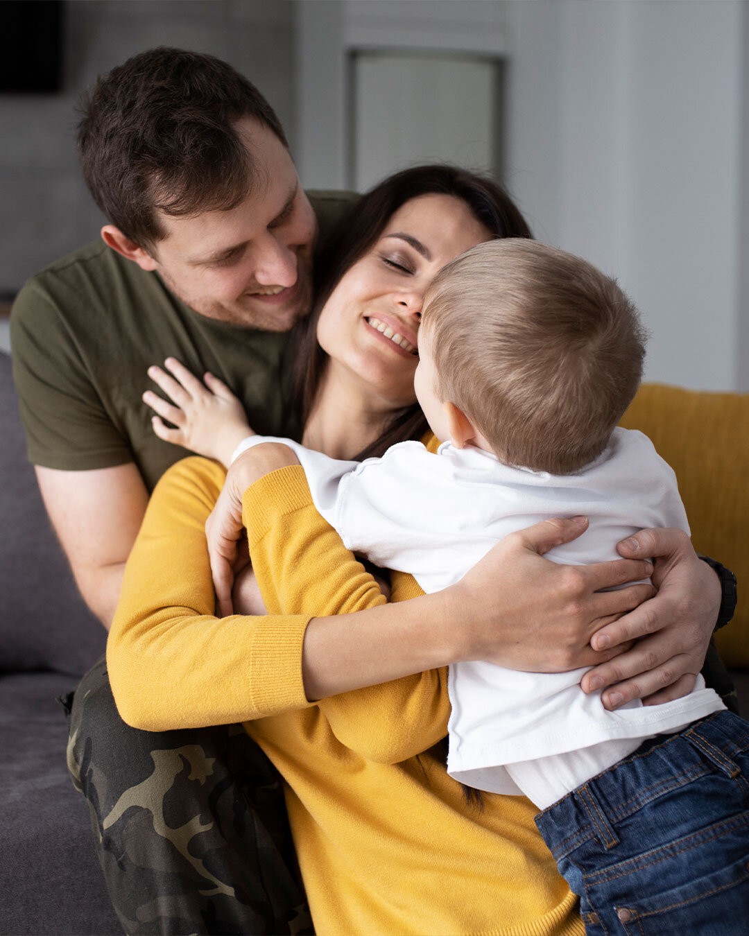 Happy family embracing at home.